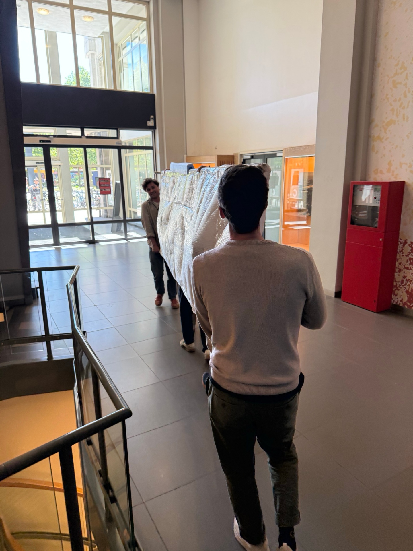 Carrying a long table through the lobby